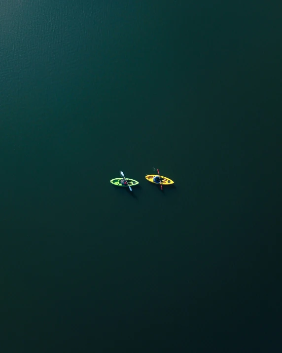 two canoes are seen from above on the water