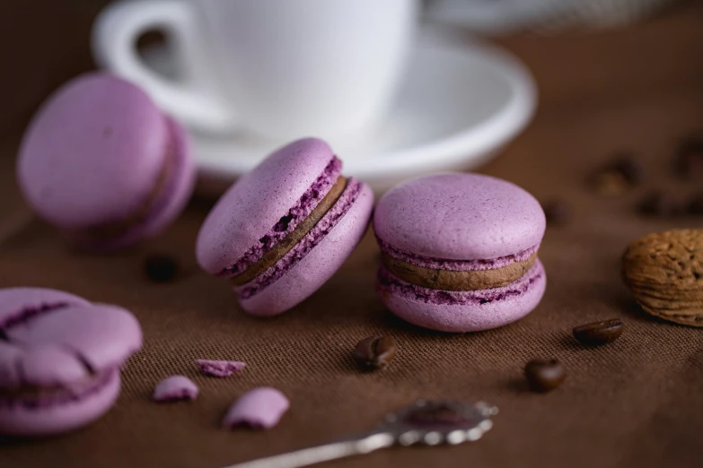 a few purple macarons and a cup of coffee