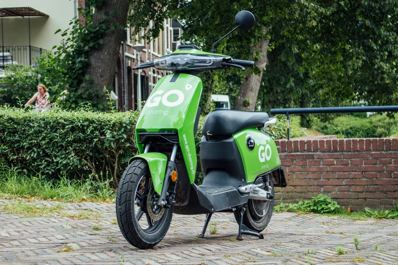 green and black motorcycle parked on the street