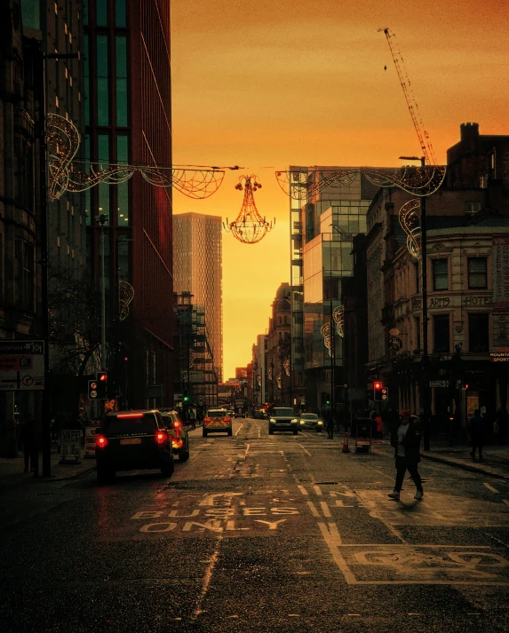 the sun is setting in the city on the street