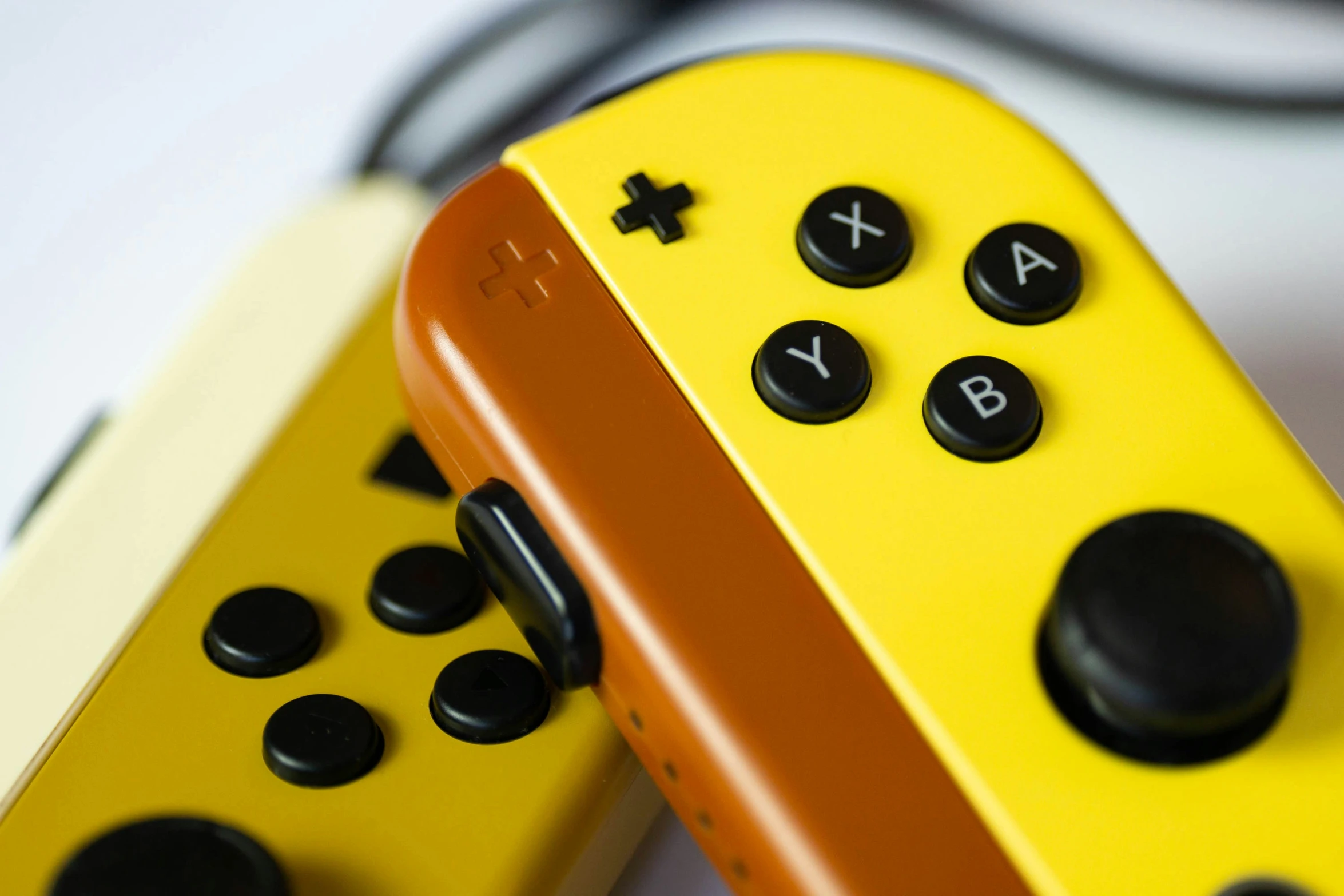 two yellow and black controller controllers with both ons are seen