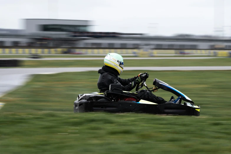 a man racing down a hill on his small, four wheeled vehicle