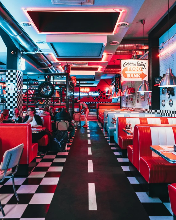 a restaurant with red and white chairs and checkered floor