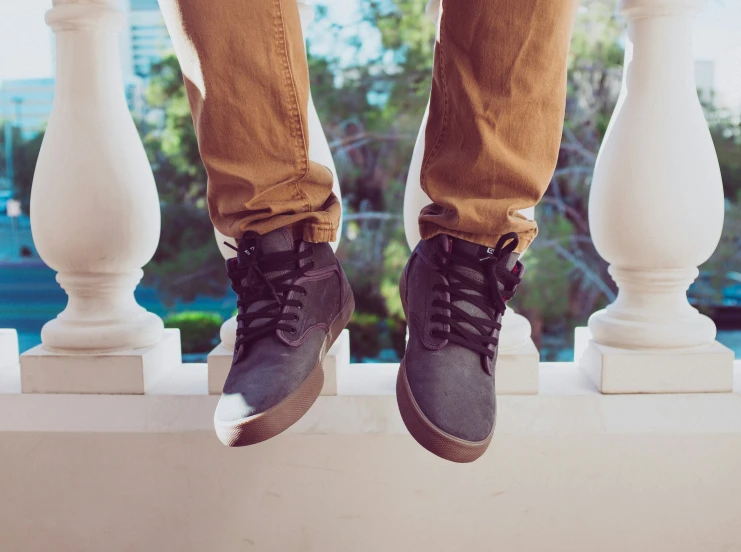 this is a man standing on top of a railing