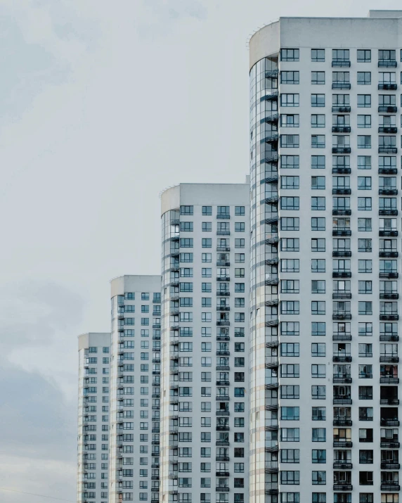 some tall buildings with one flying kite in the sky