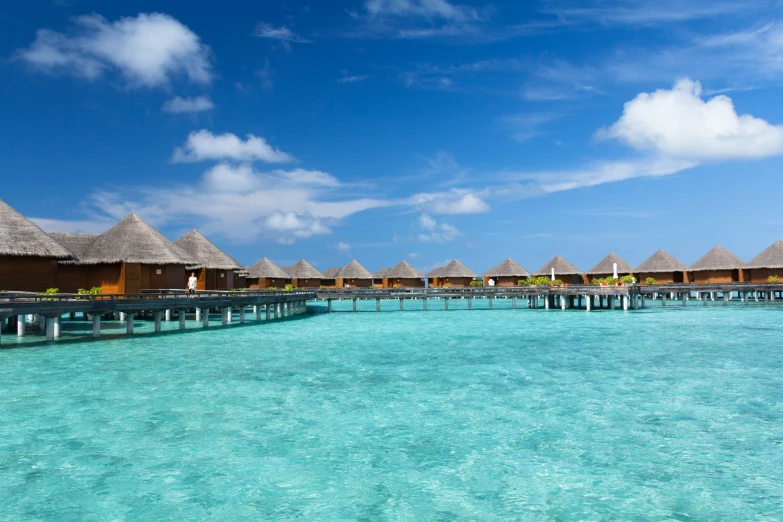 water and overwater cabanas are seen from the pier