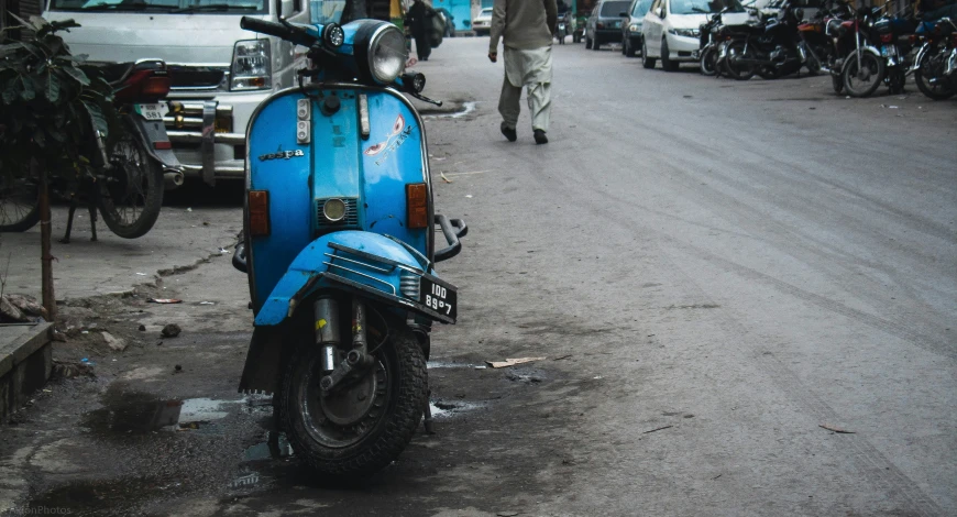 the motorcycle is parked outside the building on the road