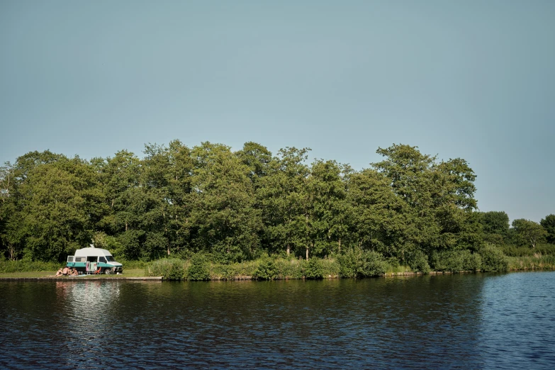 two people sitting in a boat on the river