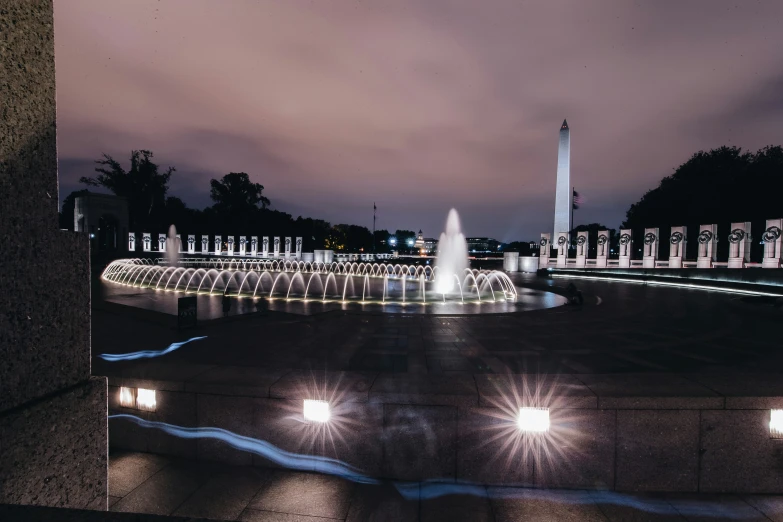 a beautiful view of a water fountain at night