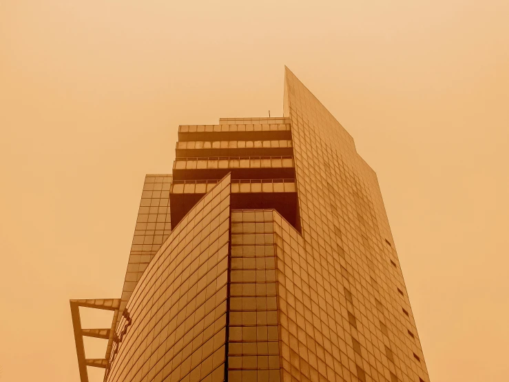 a large tall building towering over a street sign