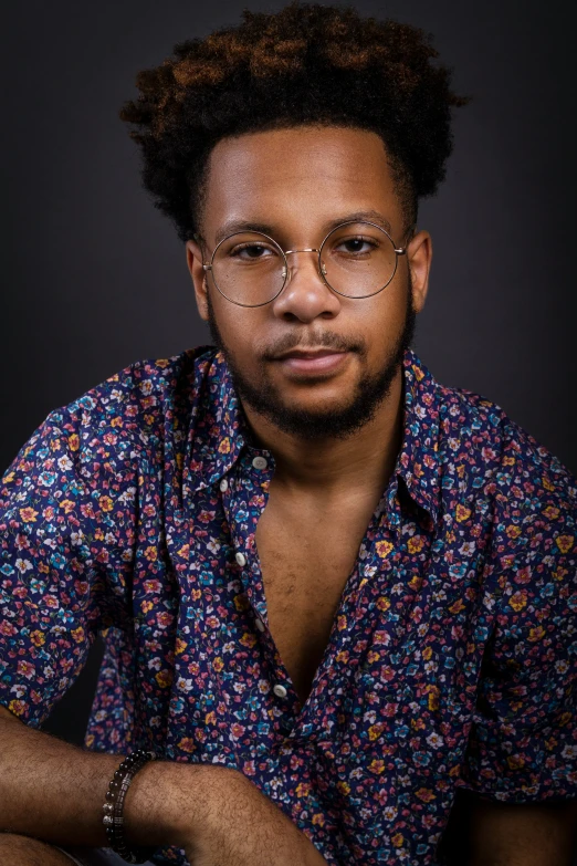 a close up image of a young man with glasses