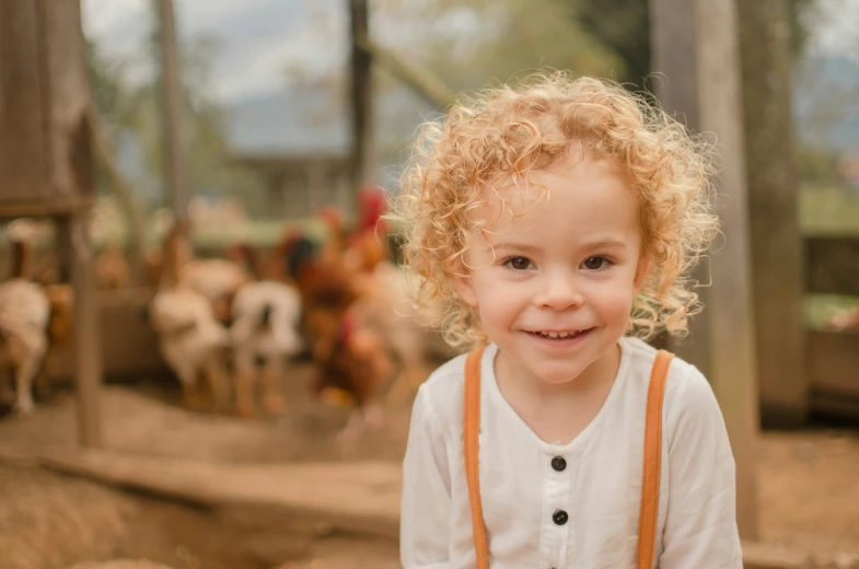 a girl with curly hair smiling at the camera