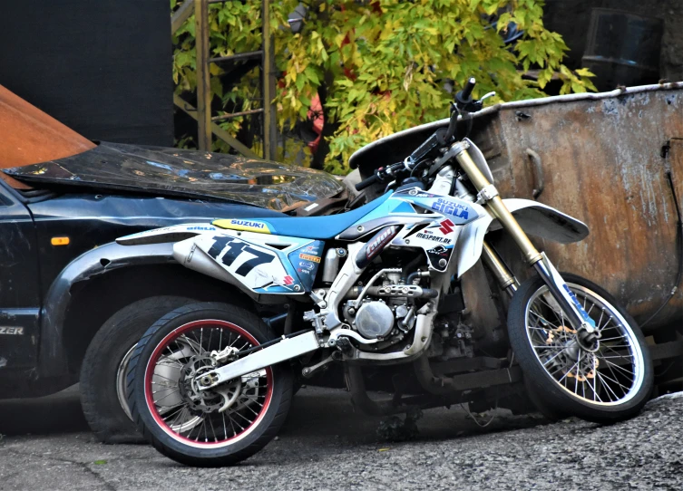 a motorcycle parked on the side of a road next to a dump truck