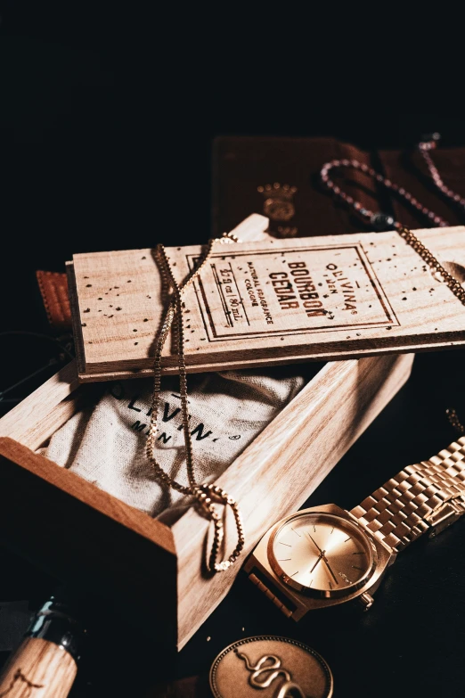 a personal wood engraved box with necklaces and watches on it