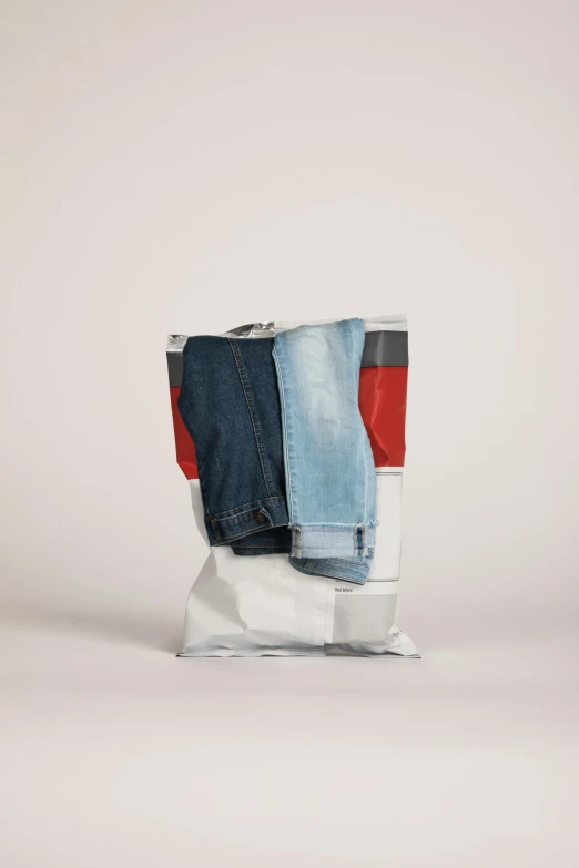 a pair of denim jeans on top of a glass