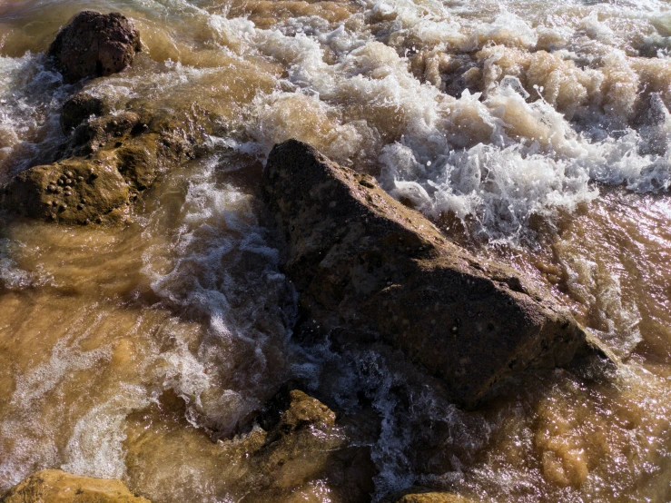 rough waters with rocks in the center of them