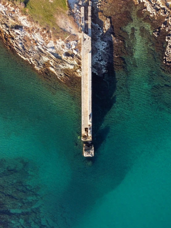 an aerial po of a dock in the ocean