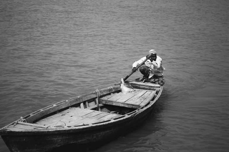 a man on the front of a boat in water