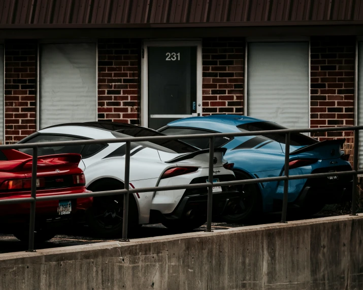 there are two colorful sports cars parked next to each other