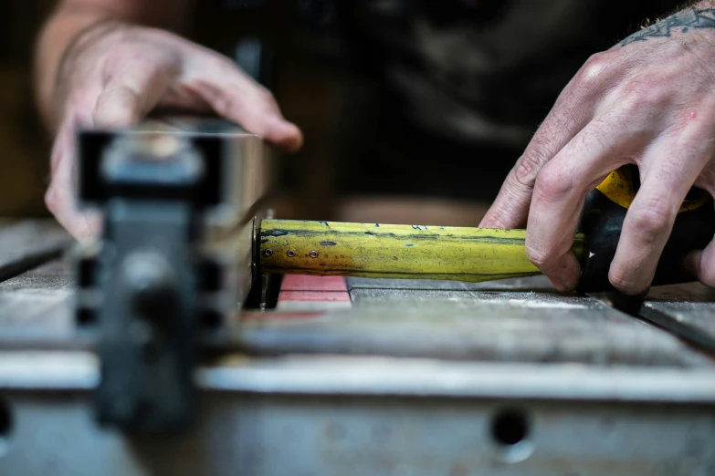 an overhead view of a person carving a banana with a large piece of wooden carving on it