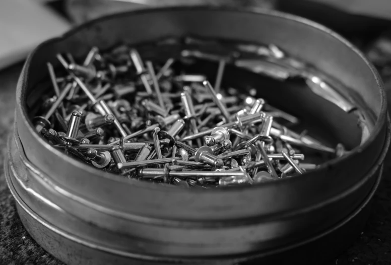 a tin filled with lots of different types of screws