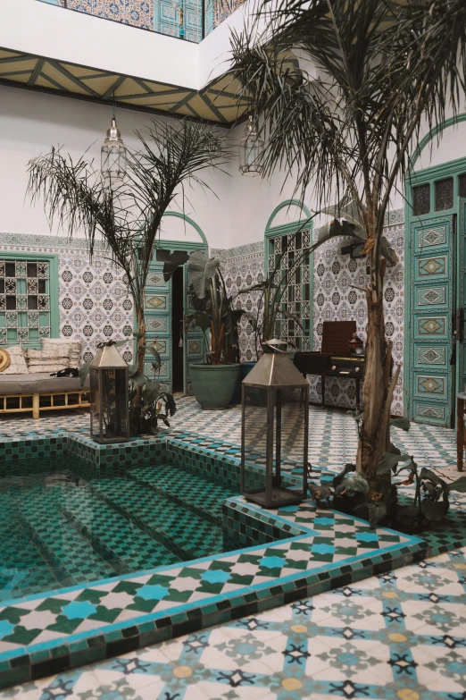 a large room with tiles and palm trees