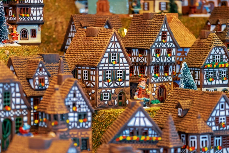 a large collection of dollhouse houses covered in straw