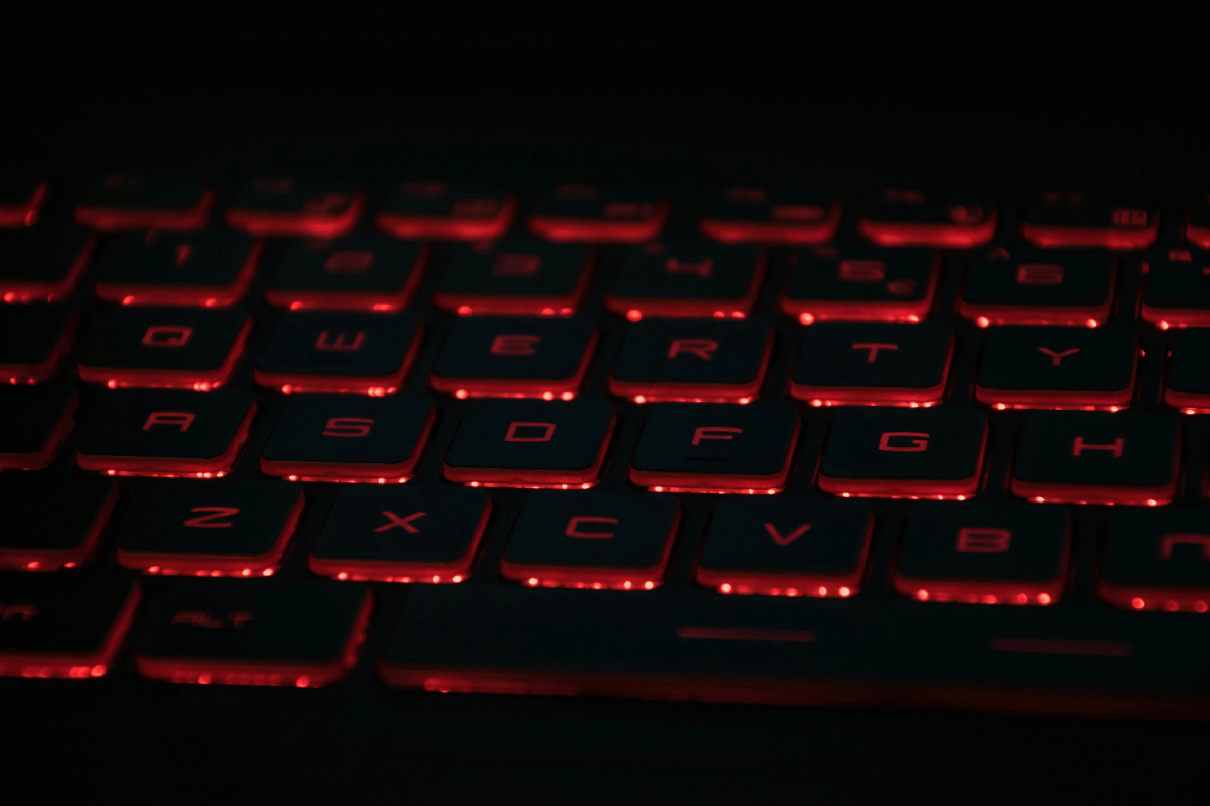a black background shows a glowing keyboard in red lighting