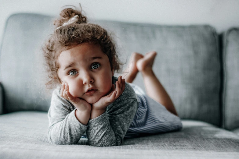  lying on the couch with her hands behind her chin