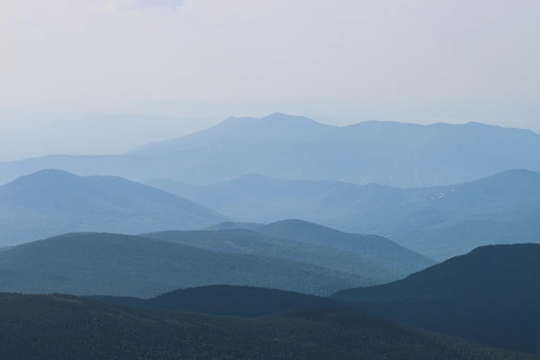 a distant view of a mountain range during a foggy day