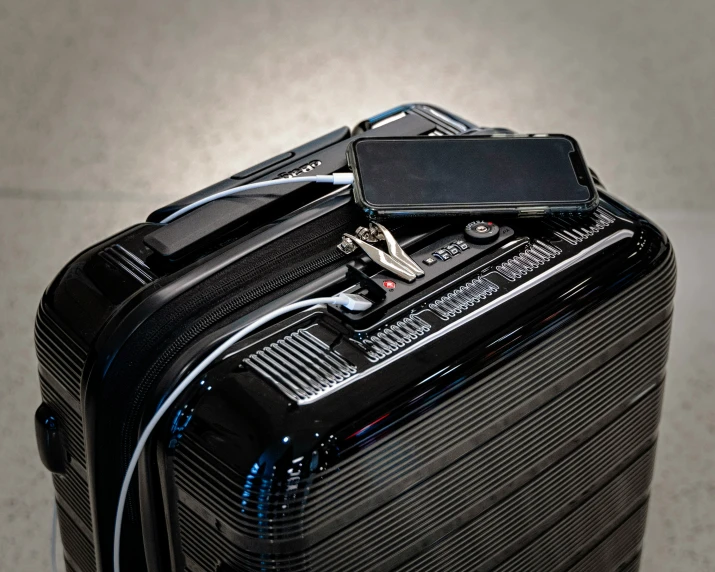 a suitcase with electronic devices on top