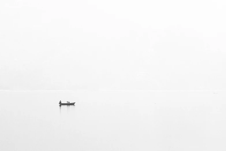 a single boat floating on a large body of water