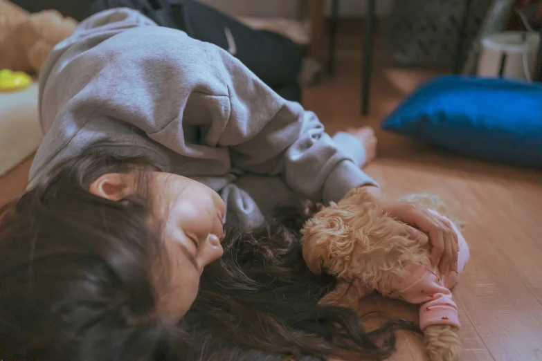 the girl is smiling as she plays with her dog