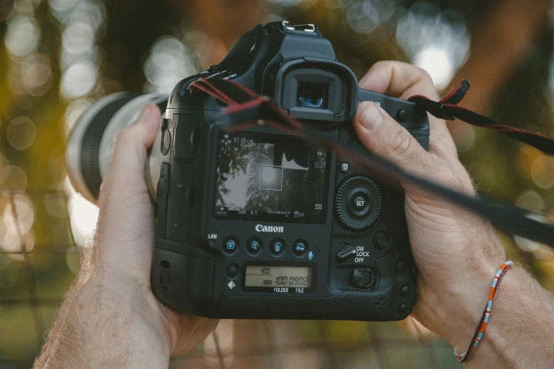 someone holding up a camera in front of their face