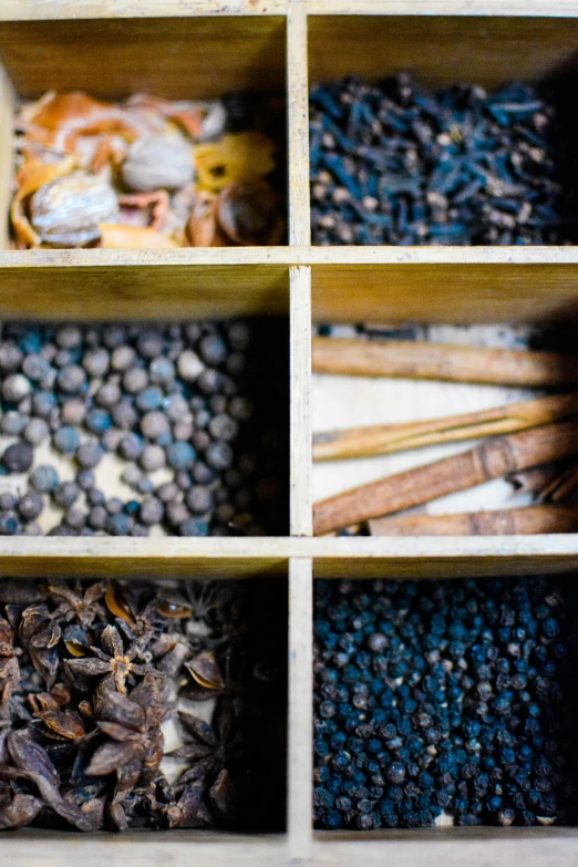 various spices in wooden containers for sale