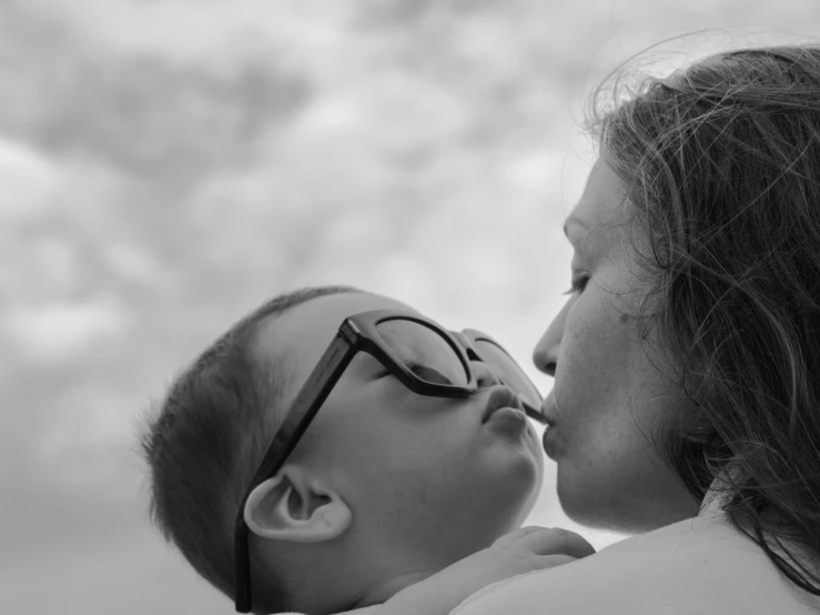 an adult is holding a baby in her arms