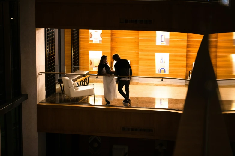 two people walking through a museum display hall