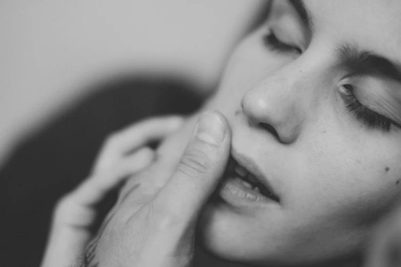 a close up of a person holding his chin