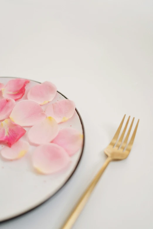 a plate with flowers and a fork next to it