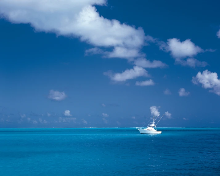 a large boat traveling across the ocean under a cloudy sky