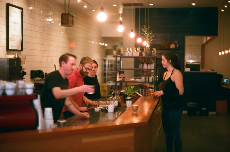 people standing at a counter in a restaurant