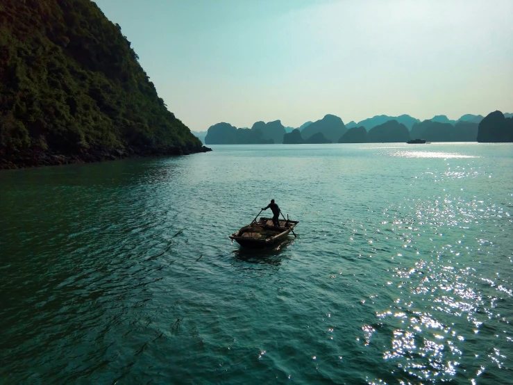 a person in a rowboat on a river