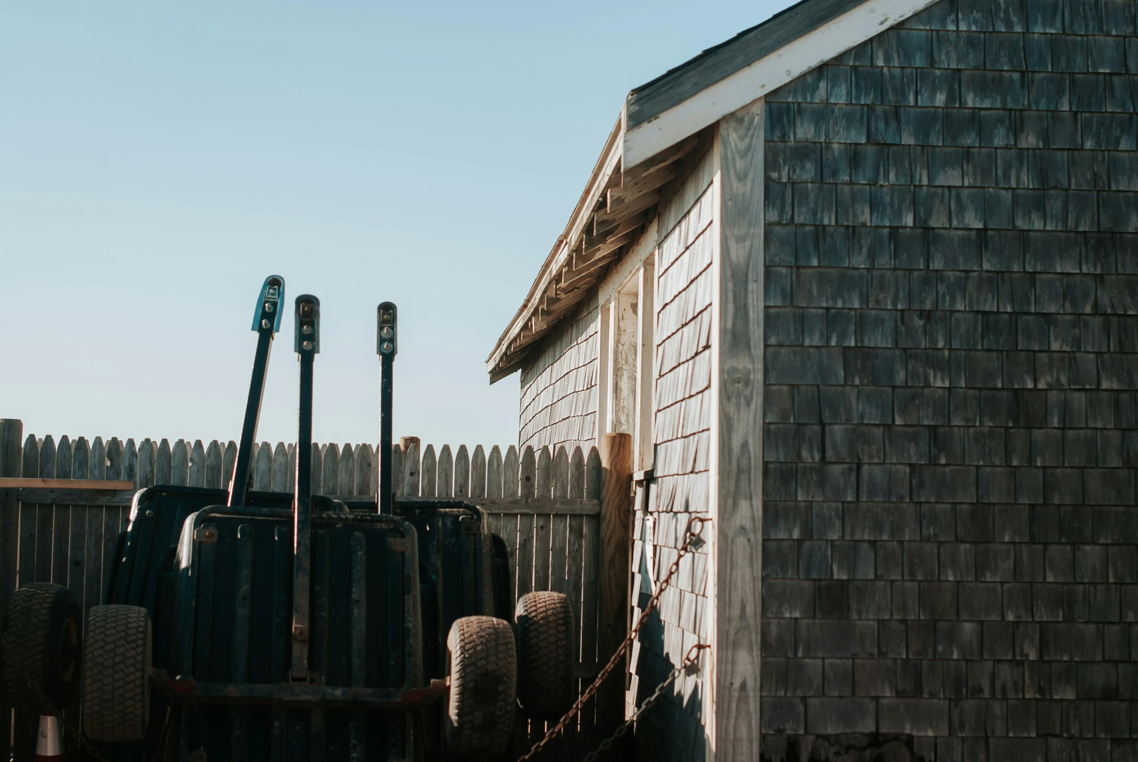 a old, abandoned house and equipment in front of it