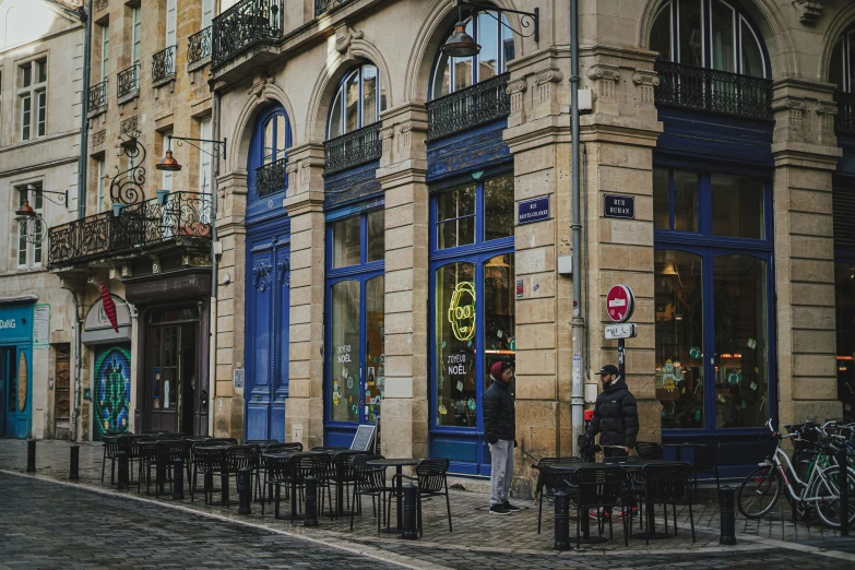 a person walking down a street past many buildings