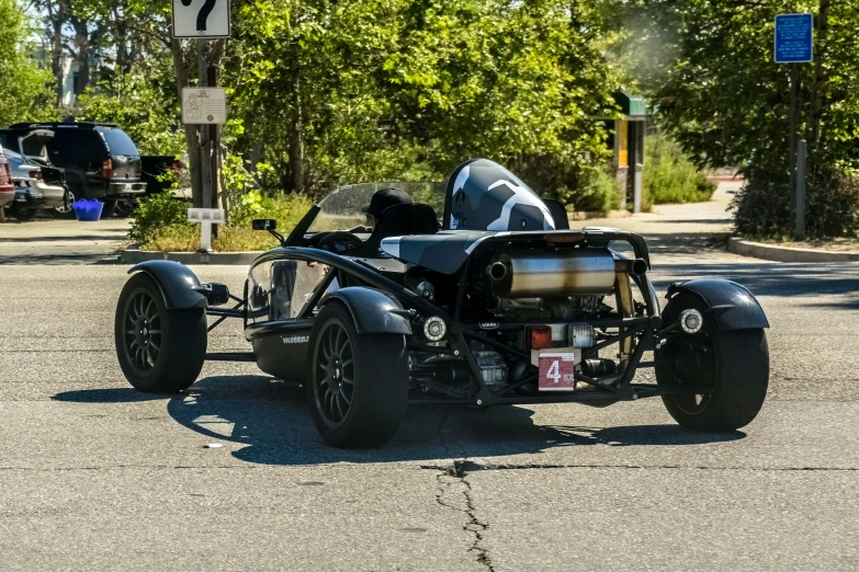 the motorcycle is parked on the road behind another vehicle