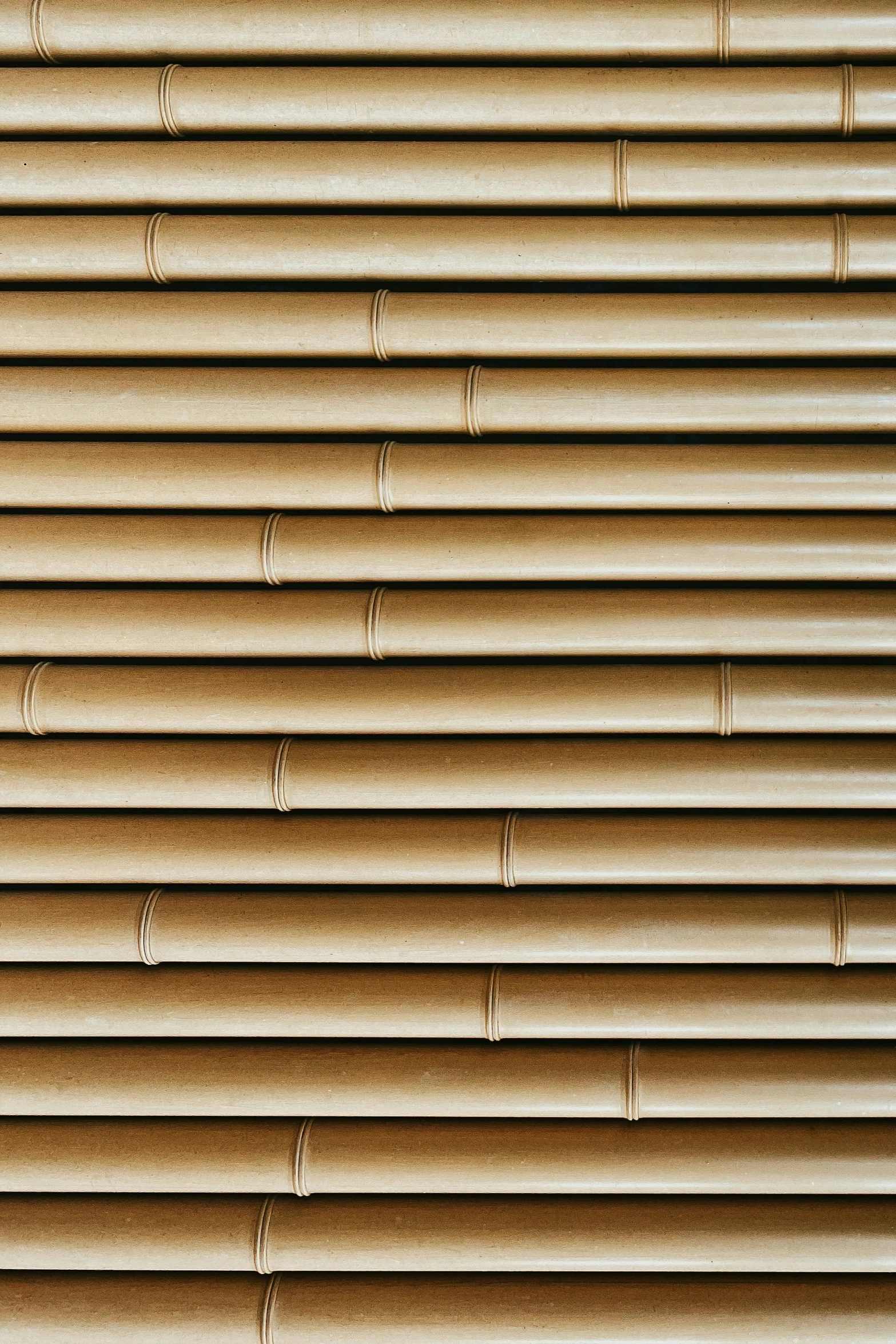 beige horizontal blinds with long vertical ends on window