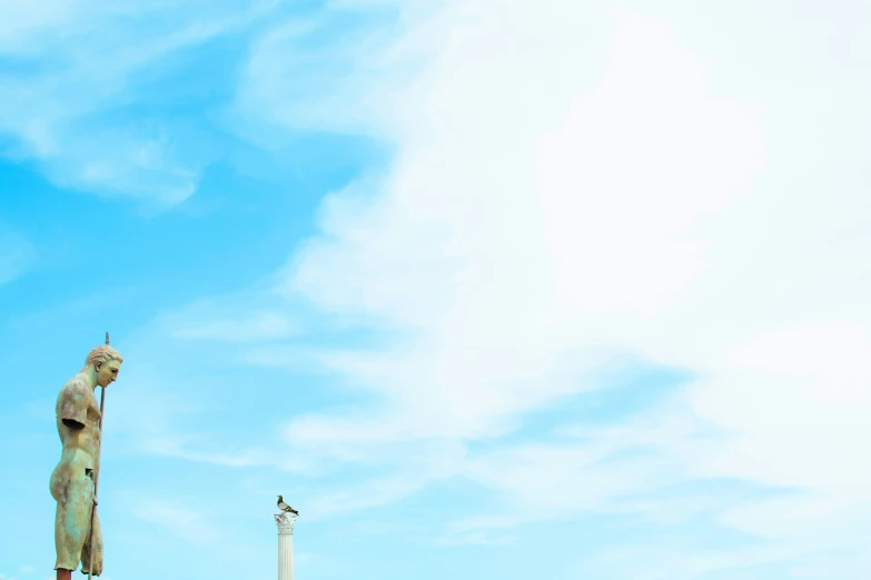 statue of an person near the top of a building