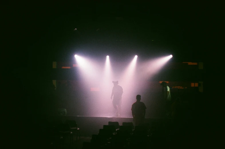 a man is standing alone in front of some lights