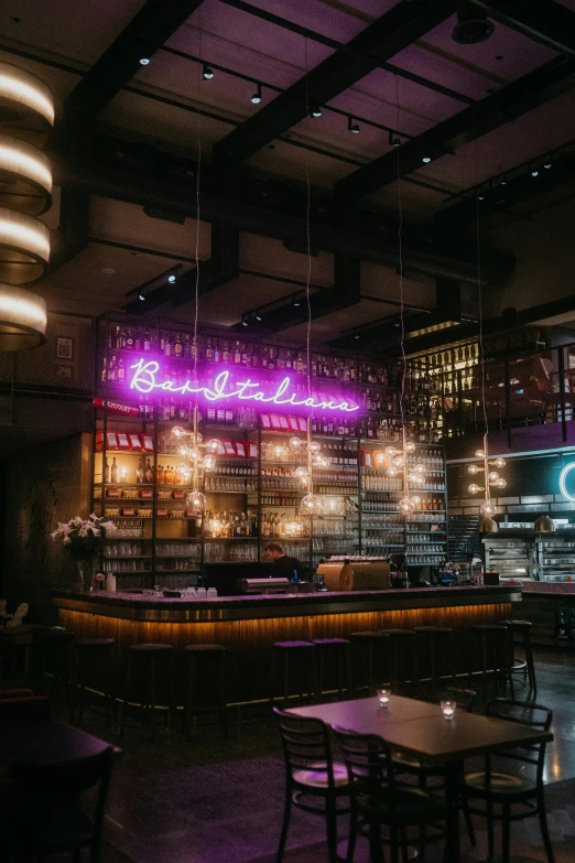 the purple and pink lights decorate the bar area of this restaurant