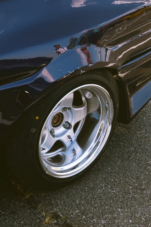 a closeup of the wheel rim and the tires on a blue sports car